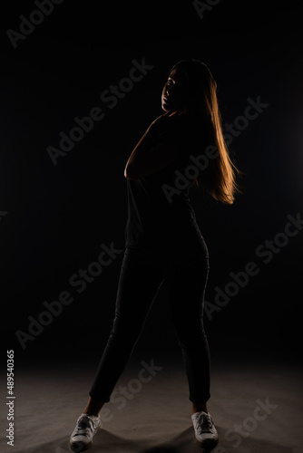 Silhouette of girl posing on grey background
