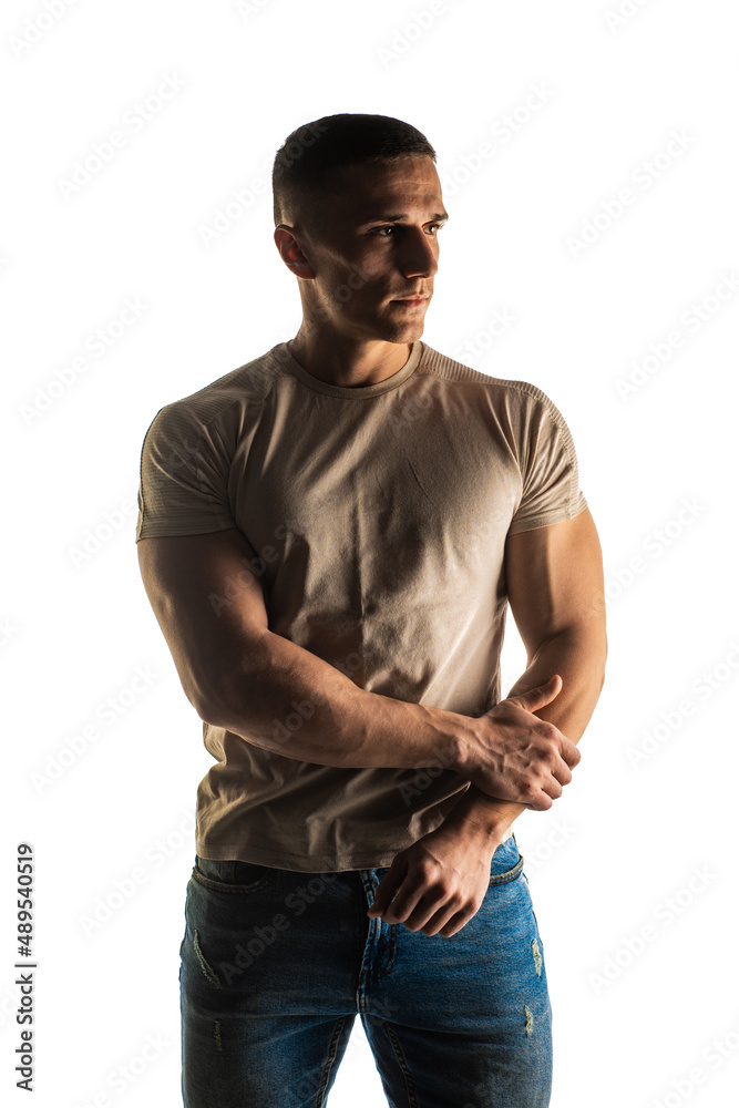 Fototapeta premium Posing and flexing on white background in studio while standing