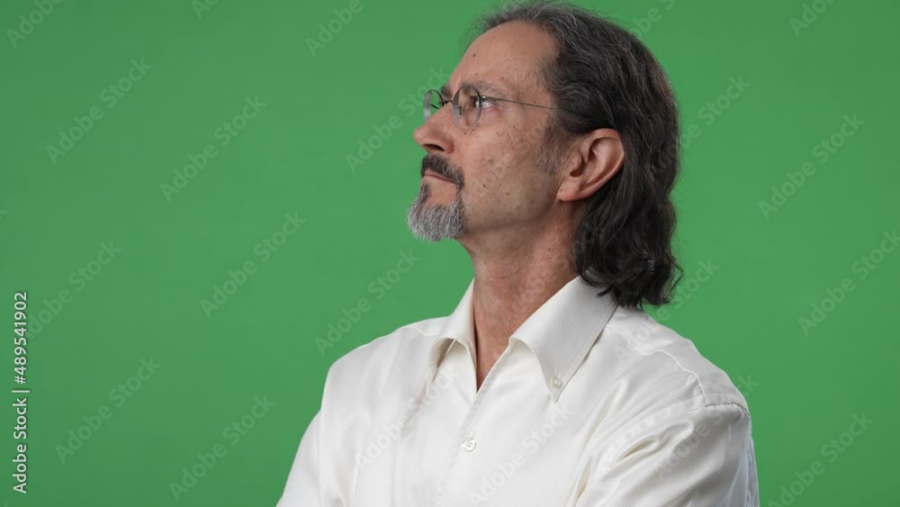 Portrait happy mature businessman looking off to side on green screen chroma key background. Portrait happy mature businessman looking off to side on green screen chroma key background.