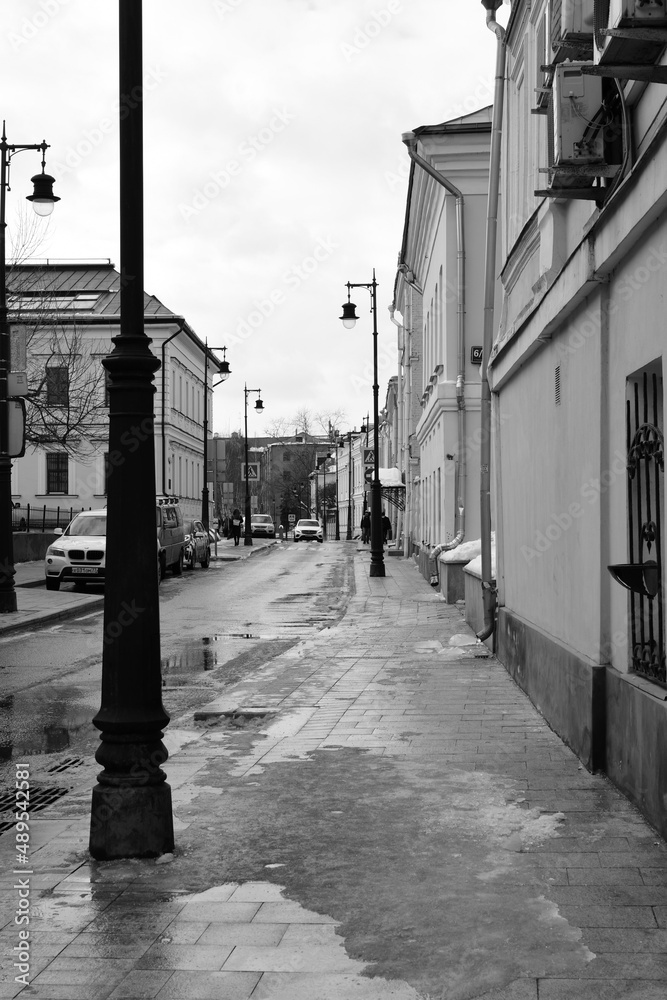 Black and white photography. View of the street with old two-story houses. February 11, 2022, Moscow, Russia.