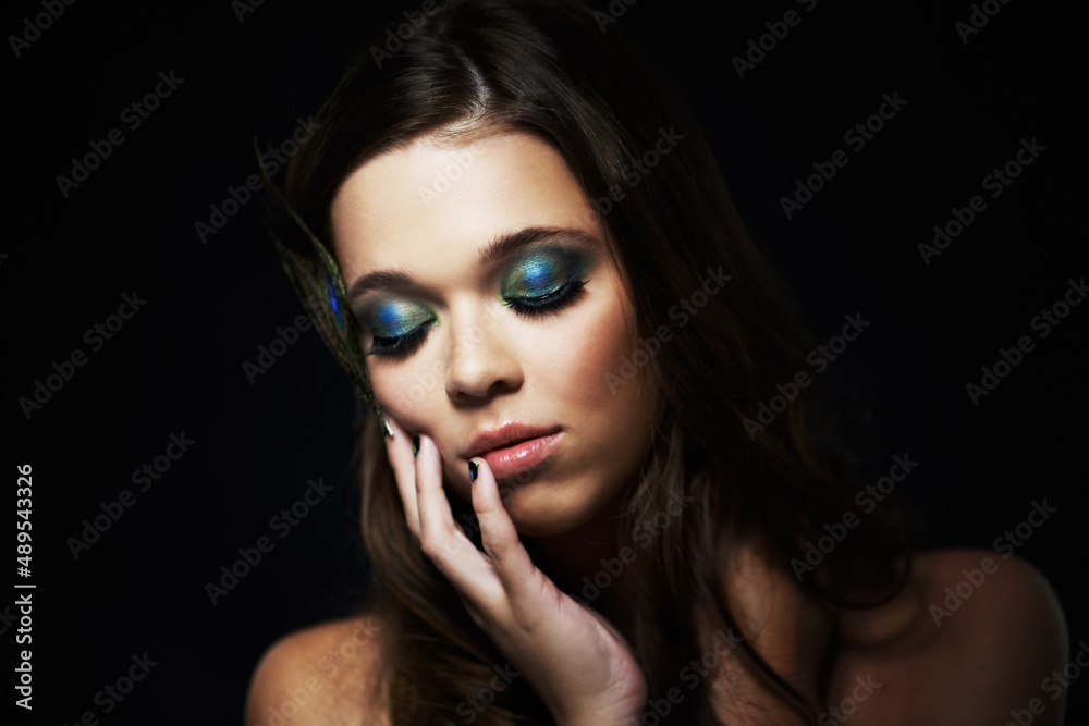 Bright eyeshadows create a dramatic look. Shot of a beautiful young woman with her eyes closed and dramatic makeup. Bright eyeshadows create a dramatic look. Shot of a beautiful young woman with her eyes closed and dramatic makeup.
