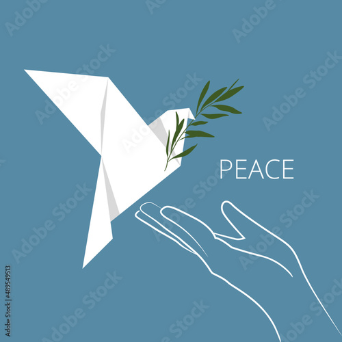 A white dove of peace with an olive branch flies into the palm of your hand. A symbol of peace. Origami.