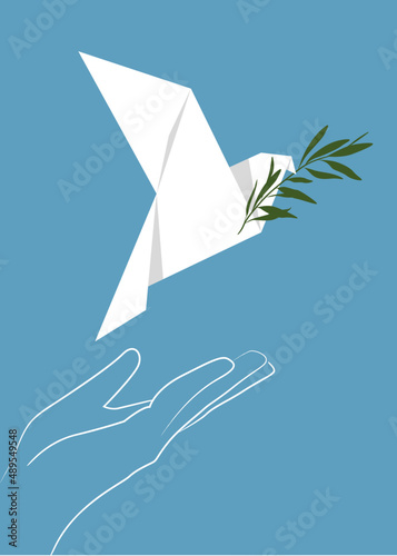 The white dove of peace flies from the palm of the hand with an olive branch in its beak. Origami. A symbol of peace. Postcard, banner for the International Day of Peace.