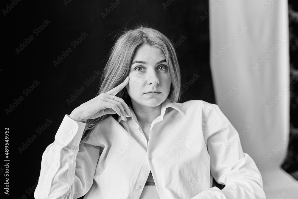 Portrait of a young European girl in a white shirt. natural portrait