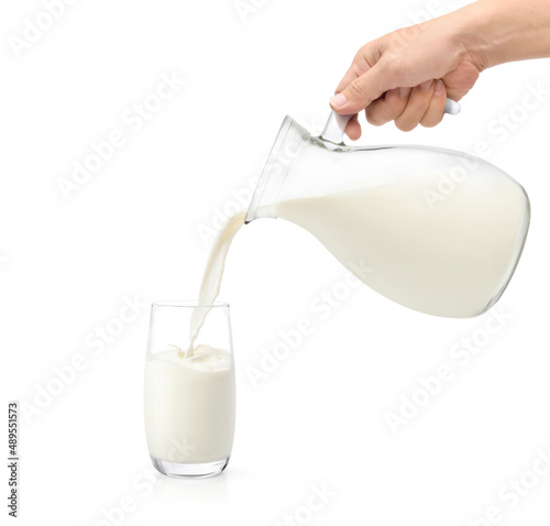 Pouring fresh milk into the glass isolated on white background.