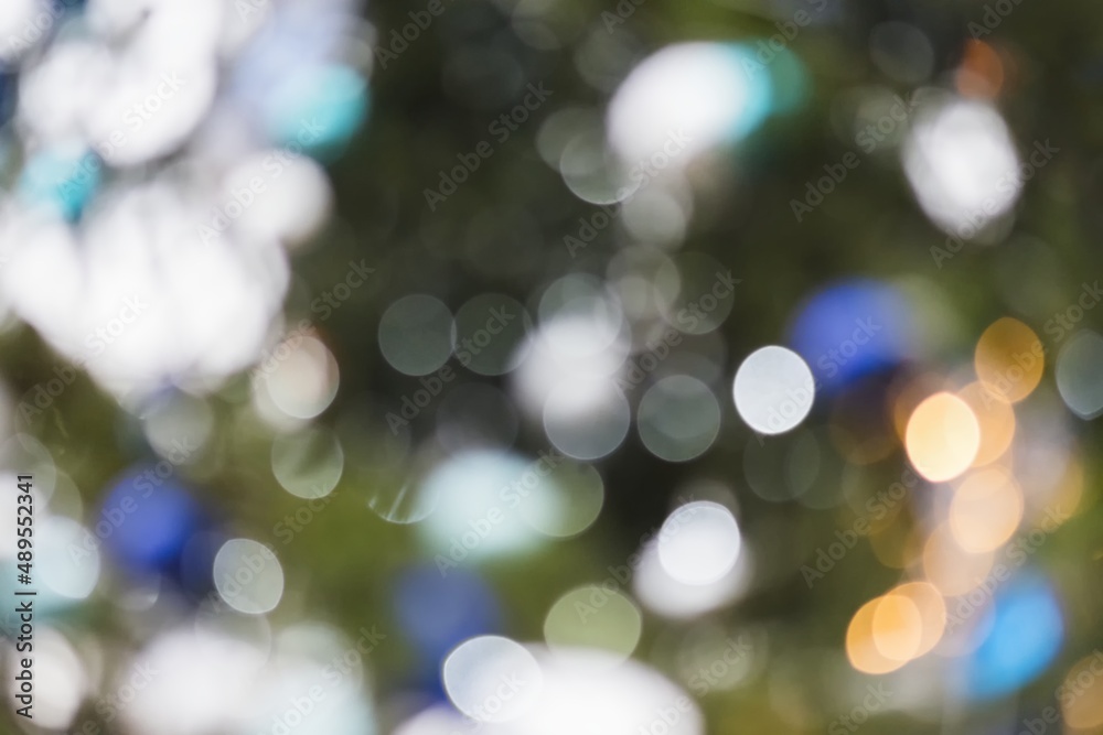 Background. In bokeh, evening city, Christmas trees, lamps, lights and ornaments. Tree alley in background. Christmas atmosphere for markets, city centers. People. Background. In bokeh, evening city, Christmas trees, lamps, lights and ornaments. Tree alley in background. Christmas atmosphere for markets, city centers. People.