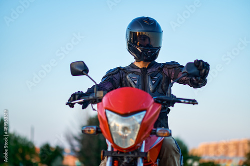 Fototapeta Naklejka Na Ścianę i Meble -  Student poses on motorbike, motorcycle school