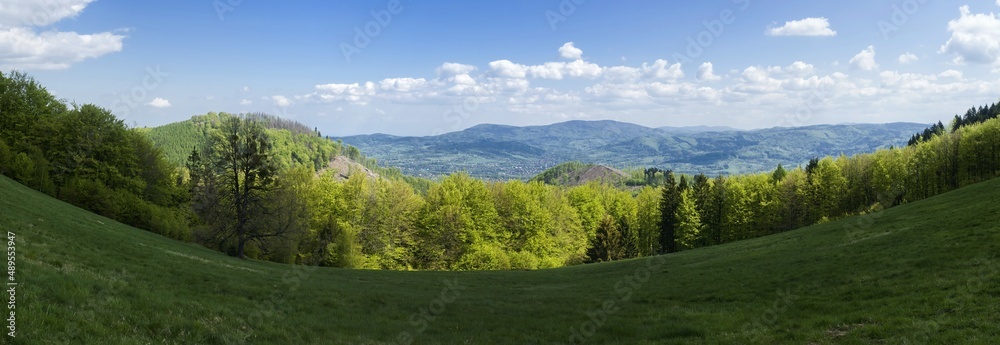 Landscape photography, image Czech Republic. Beskydy. Meadow, in the middle of the woods and mountains, in the background sky with clouds.