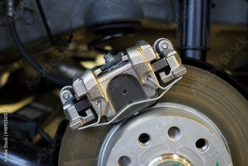 The braking system of a modern car. Brake caliper installed on the car. Car service, auto parts.