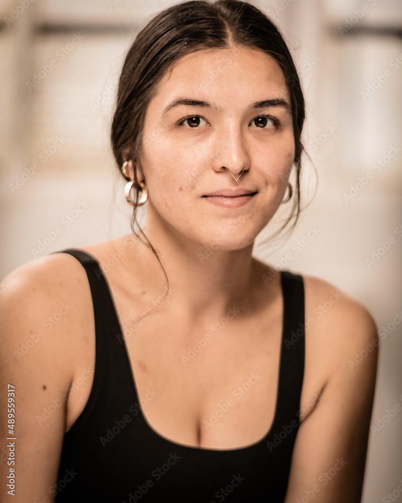 Young Los Angeles yoga teacher sits in an industrial setting after a session of practice. Young Los Angeles yoga teacher sits in an industrial setting after a session of practice.