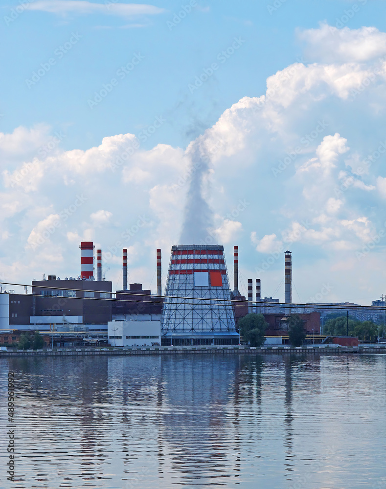 Thermal power plant with cooling tower on the bank of the reservoir Thermal power plant with cooling tower on the bank of the reservoir
