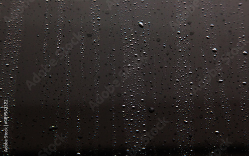 Raindrops on a black surface.