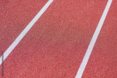 detail of the red tartan surface with white line, sporting terrain, life of the athlete