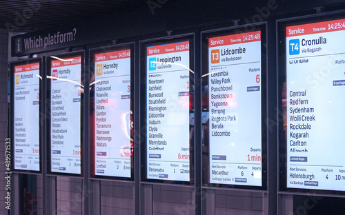 Illuminated platform and train signage at a station photo