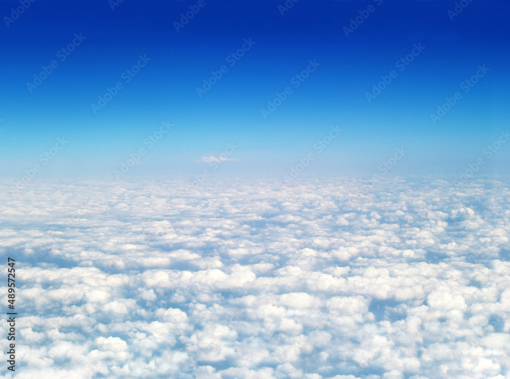 White clouds against a blue sky. White cumulonimbus clouds floating in the blue sky. White clouds against a blue sky. White cumulonimbus clouds floating in the blue sky.