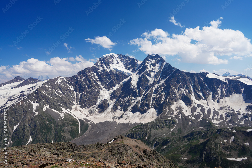Steep slopes of the Altai Mountains covered with eternal snow