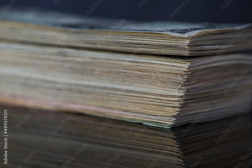 A lot of American dollars banknotes on a dark background. A lot of American dollars banknotes on a dark background.