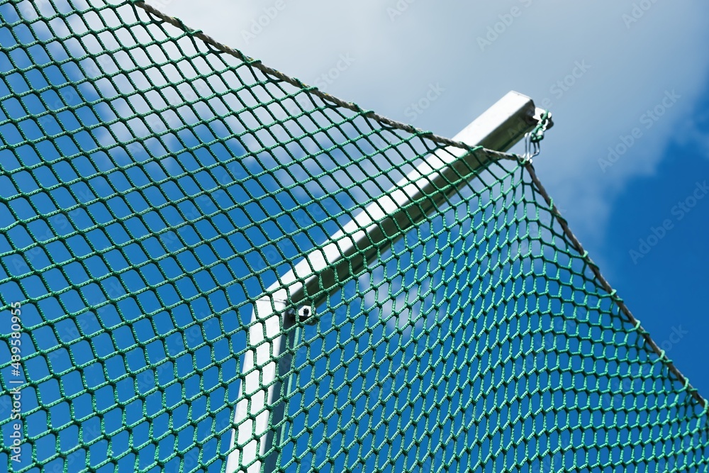 Green Protection Netting. Athletic stadium. Beautiful sunny weather. Sector: Shot Put and Hammer. Green Protection Netting. Athletic stadium. Beautiful sunny weather. Sector: Shot Put and Hammer.
