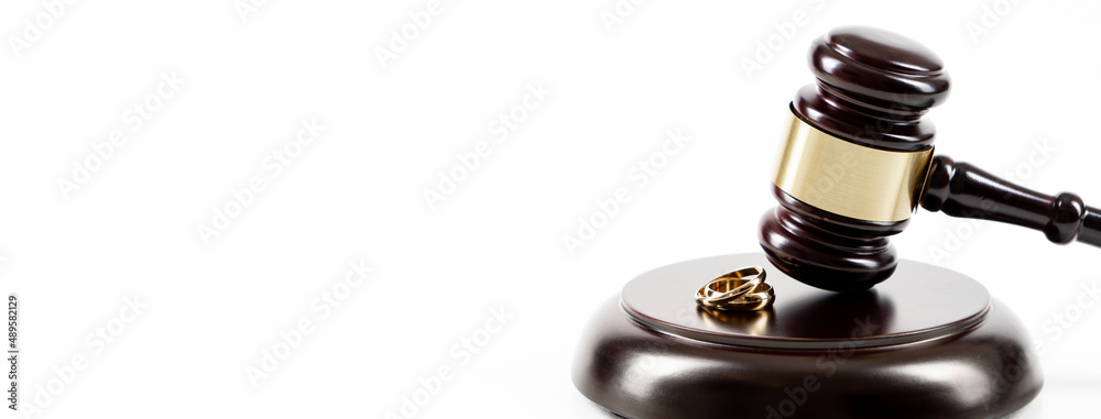Wedding rings on the figure of a broken heart from a tree, hammer of a judge. Divorce divorce proceedings. Judge hammer wedding ring with copy space Wedding rings on the figure of a broken heart from a tree, hammer of a judge. Divorce divorce proceedings. Judge hammer wedding ring with copy space
