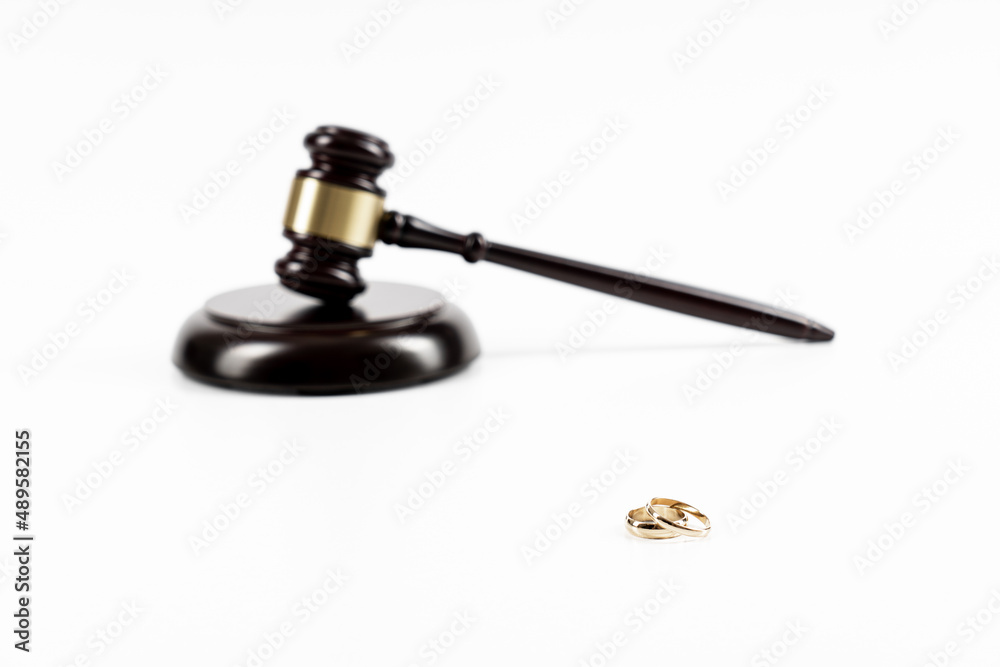 Wedding rings on the figure of a broken heart from a tree, hammer of a judge. Divorce divorce proceedings. Judge hammer wedding ring with copy space Wedding rings on the figure of a broken heart from a tree, hammer of a judge. Divorce divorce proceedings. Judge hammer wedding ring with copy space
