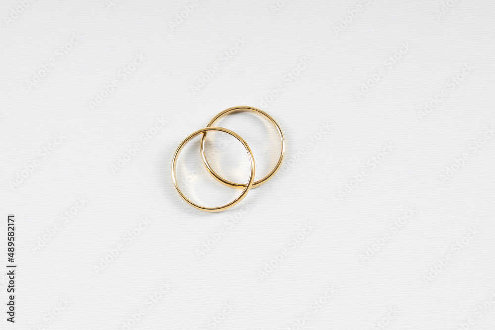 Gold wedding rings on a white background with copy space Gold wedding rings on a white background with copy space
