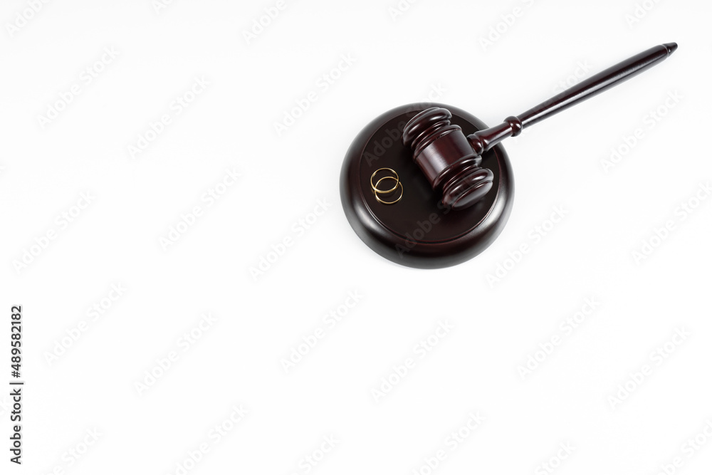 Wedding rings on the figure of a broken heart from a tree, hammer of a judge. Divorce divorce proceedings. Judge hammer wedding ring with copy space