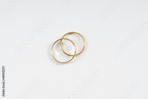 Gold wedding rings on a white background with copy space