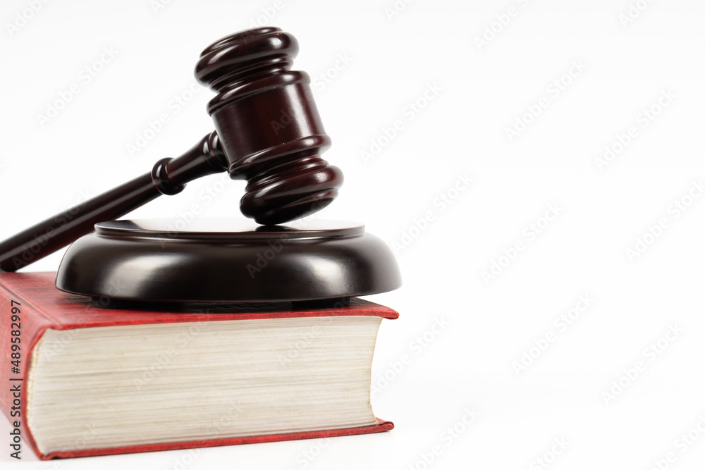 Law concept - law book with a wooden judge's gavel on table. Copy space for text