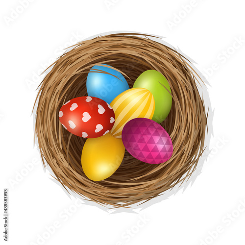 Easter eggs on wild bird nest from straw and twigs