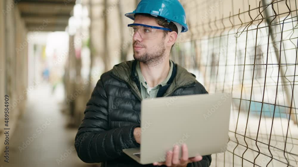Young man architect using laptop at street Young man architect using laptop at street