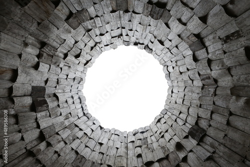 Dark wooden pattern with circle. Background with wood pieces. Art by Nikolai Polissky in Kaluga region, Russia. Contemporary architecture. Modern art. Black round window. Wooden backdrop. Wood pattern