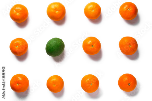 eleven oranges and one lime on a white background, isolated