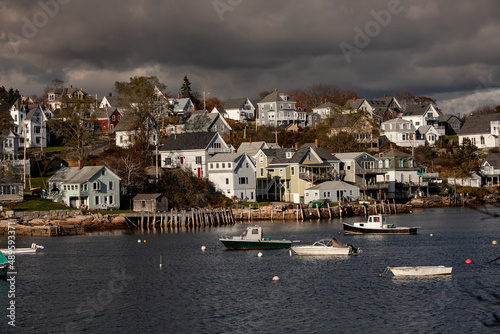 Lobster boats at anchor and bay front homes, Stonington, Maine photo