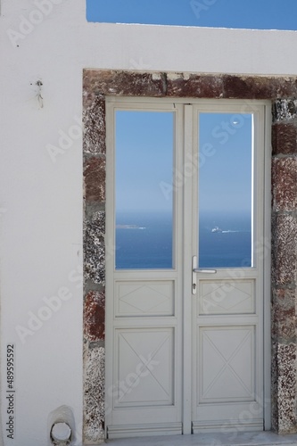 A typical door in Santorini with a breathtaking view of the Aegean Sea and the blue sky © DIMITRIOS