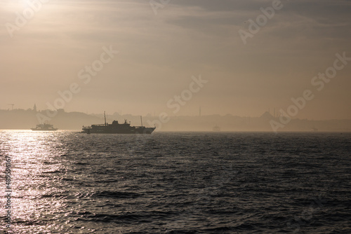 Istanbul background. Silhouette of Istanbul and a ferry at foggy weather
