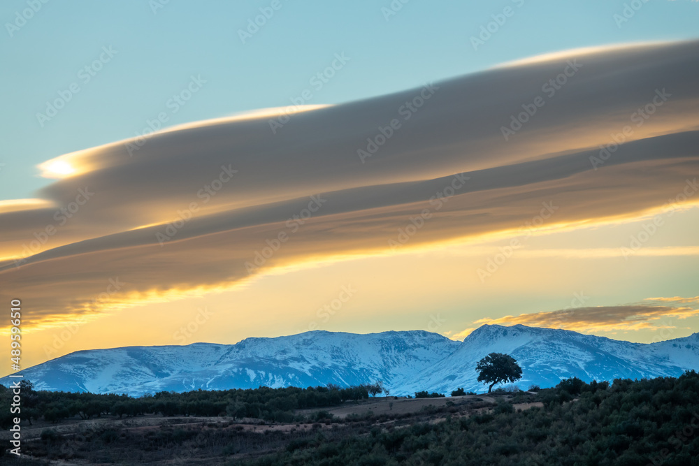 Large lenticular clouds over Sierra Nevada at sunrise Large lenticular clouds over Sierra Nevada at sunrise