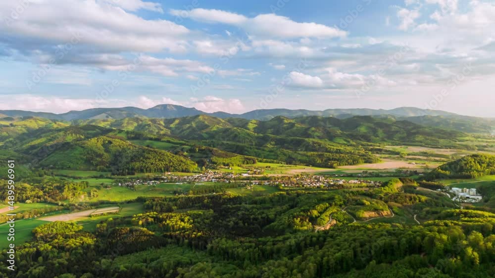 Aerial view flying over rural northern european town in foothills of Alps Aerial view flying over rural northern european town in foothills of Alps
