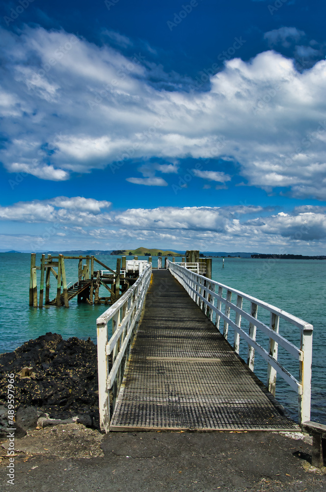 The jetty of the ferry to Auckland on the volcanic Rangitoto Island in Auckland Bay. North Island, New Zealand, 
