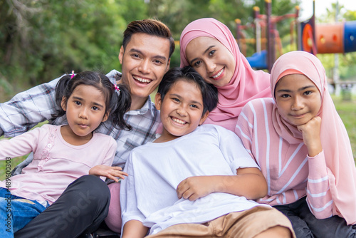 young parent with 3 kids at the park