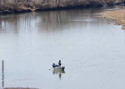 Man on Colorado river fishing on a winter day