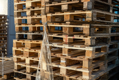 Stacked wooden pallets at a storage or near a shop