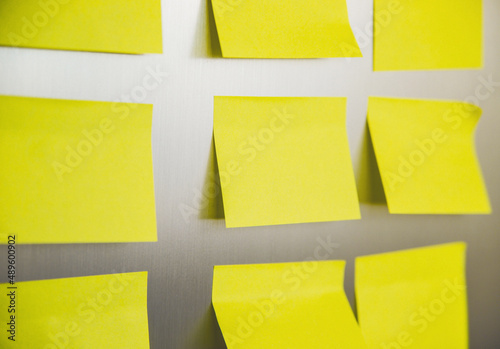 Yellow square stickers are glued to the refrigerator. Sheets for recording information.