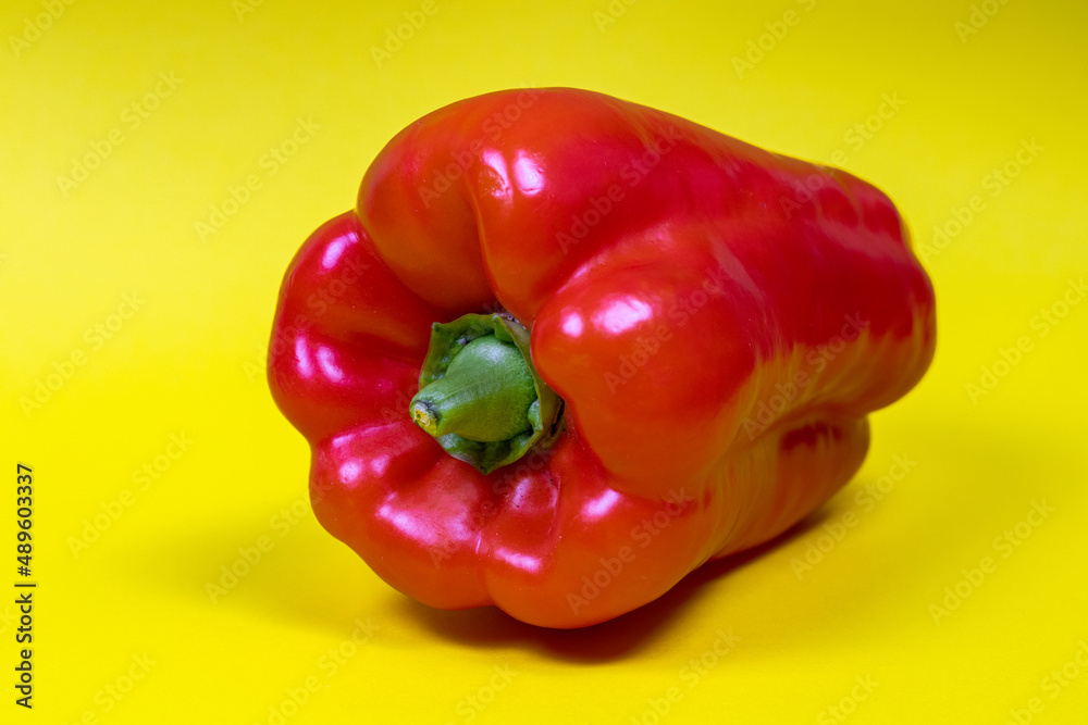 Red bell pepper isolated on yellow background Red bell pepper isolated on yellow background