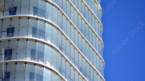 Glass facade of a modern housing construction with of balconies.