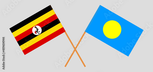 Crossed flags of Uganda and Palau. Official colors. Correct proportion
