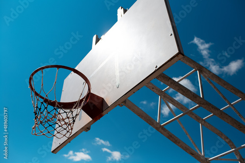 Outdoor basketball hoop in sunny day of summer.