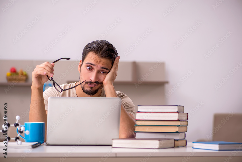 Young male student studying at home during pandemic Young male student studying at home during pandemic