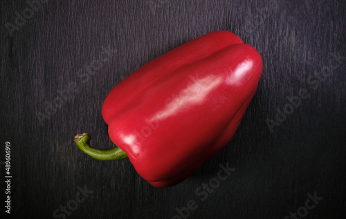 Red bell pepper. Top view. Dark background. Overhead view of fresh organic vegetables on black table.