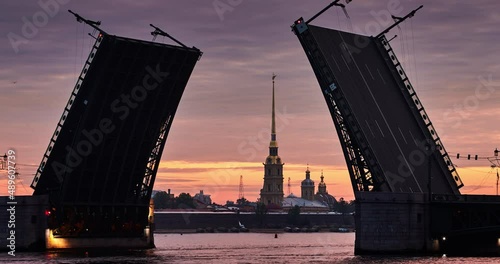 Time lapse of rise the Palace Bridge at early morning , drawbridge is brought down after the completion of sea navigation, the Peter and Paul fortress on a background, fort Petropavlovskaya photo
