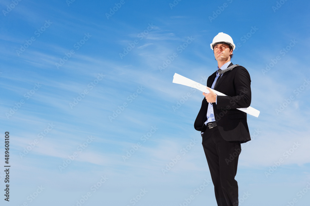 An architect with blueprints standing against clear sky. Business blueprint - An architect with papers standing against clear sky. An architect with blueprints standing against clear sky. Business blueprint - An architect with papers standing against clear sky.